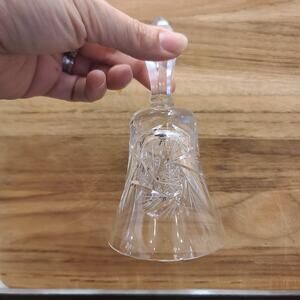 A vintage hand-cut lead crystal glass bell with intricate geometric patterns